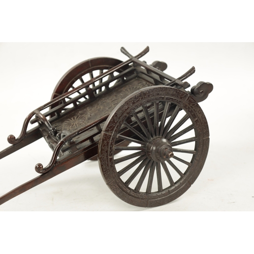 135 - A JAPANESE MEIJI PERIOD PATINATED BRONZE MODEL OF A CARRIAGE with floral decoration and spoke wheels... 