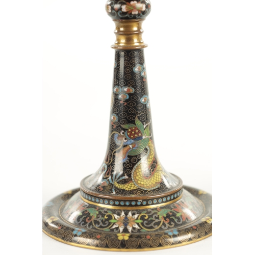 137 - A PAIR OF EARLY 20TH CENTURY CHINESE CLOISONNE CANDLESTICKS decorated with five claw dragons on a bl... 