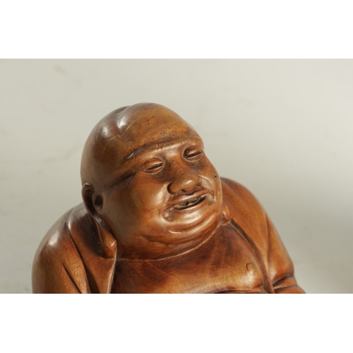139 - A 19TH CENTURY CHINESE HARDWOOD CARVED SCULPTURE modelled as a seated Buddha (11cm high )
