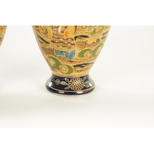 156 - A LARGE PAIR OF JAPANESE SATSUMA VASES decorated with figures, having gilt highlights on a blue grou... 