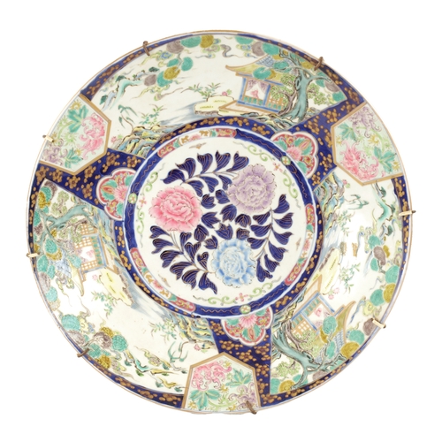 181 - A JAPANESE MEIJI PERIOD PORCELAIN CHARGER with landscape panels to the border surrounding a floral c... 