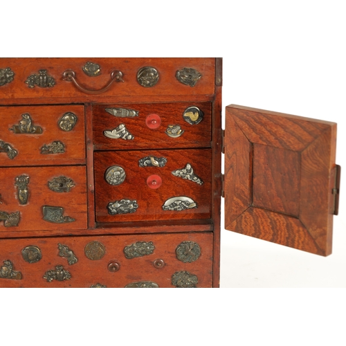 189 - A JAPANESE MEIJI PERIOD STAINED WOOD COLLECTOR'S CABINET fitted with gilt bronze menuki, comprising ... 