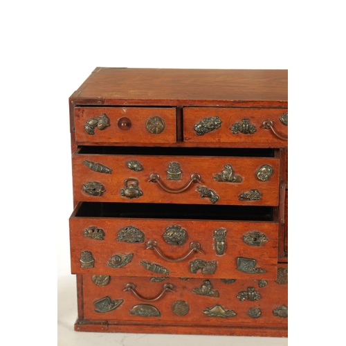 189 - A JAPANESE MEIJI PERIOD STAINED WOOD COLLECTOR'S CABINET fitted with gilt bronze menuki, comprising ... 