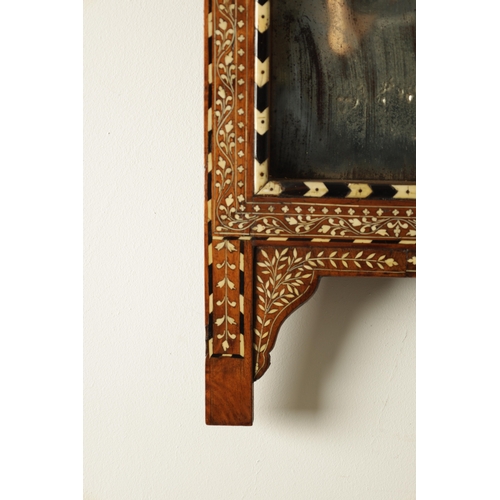 193 - A 19TH CENTURY INDIAN EBONY AND BONE INLAID HANGING MIRROR the recessed centre-looking glass enclose... 