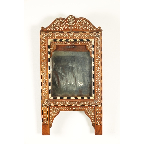 193 - A 19TH CENTURY INDIAN EBONY AND BONE INLAID HANGING MIRROR the recessed centre-looking glass enclose... 