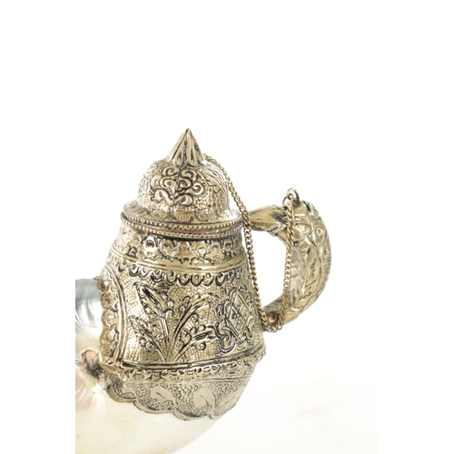 195 - AN EARLY 20TH CENTURY TIBETAN SILVER METAL AND MOTHER OF PEARL SHELL TEAPOT AND JUG with embossed de... 