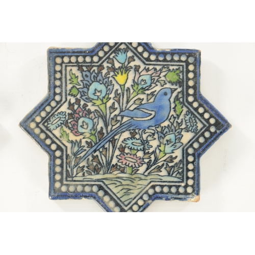 198 - TWO ISLAMIC STAR-SHAPED GLAZED CERAMIC TILES depicting birds amongst foliage. (16.5cm wide)