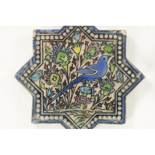 198 - TWO ISLAMIC STAR-SHAPED GLAZED CERAMIC TILES depicting birds amongst foliage. (16.5cm wide)