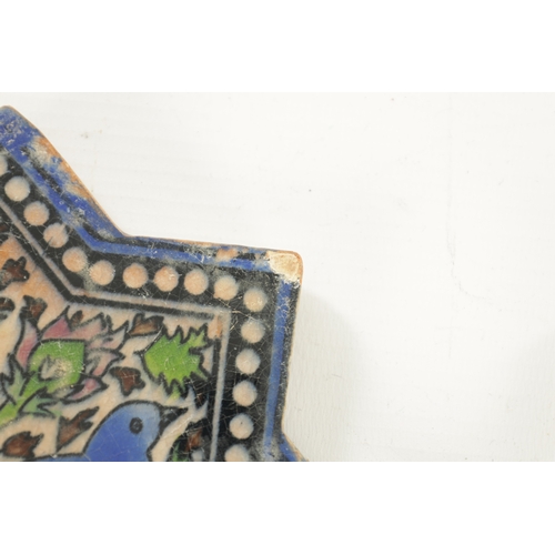 198 - TWO ISLAMIC STAR-SHAPED GLAZED CERAMIC TILES depicting birds amongst foliage. (16.5cm wide)