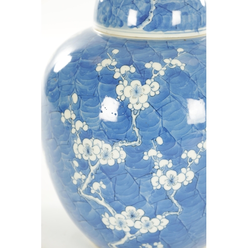 201 - A 19TH CENTURY CHINESE BLUE AND WHITE GINGER JAR AND COVER decorated with prunus blossom on a blue s... 