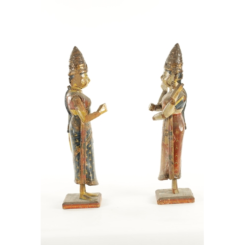 226 - A PAIR OF 19TH CENTURY POLYCHROME DECORATED INDIAN TEMPLE FIGURES with gilt highlights (51cm high )