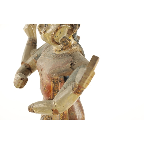 226 - A PAIR OF 19TH CENTURY POLYCHROME DECORATED INDIAN TEMPLE FIGURES with gilt highlights (51cm high )