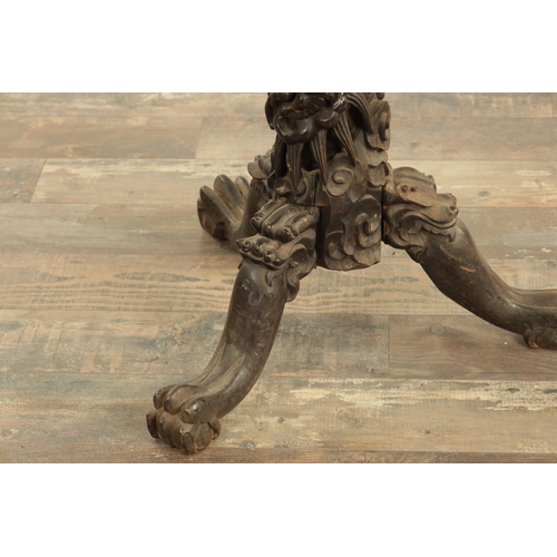 228 - A 19TH CENTURY CHINESE HARDWOOD CENTRE TABLE with leaf carved edge above an entwined dragon and flow... 