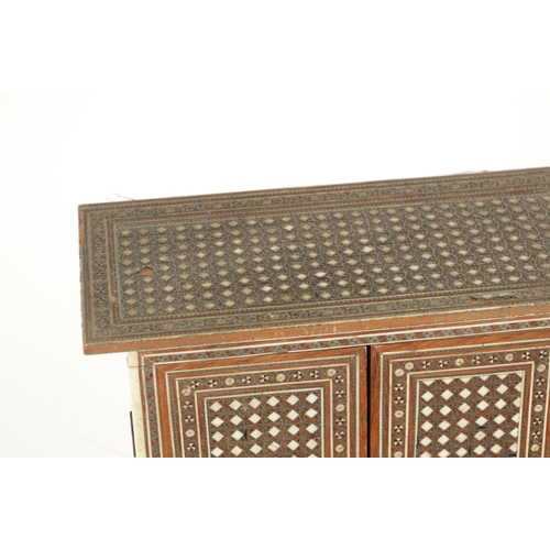 229 - A LATE 19TH CENTURY INDIAN MICRO MOSAIC TABLE CABINET the overhanging top above a two-door shelved i... 