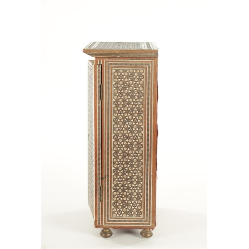 229 - A LATE 19TH CENTURY INDIAN MICRO MOSAIC TABLE CABINET the overhanging top above a two-door shelved i... 