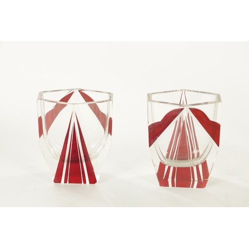 23 - AN ART DECO BOHEMIAN GLASS LIQUER SET of faceted design having six glasses with ruby red overlay, th... 