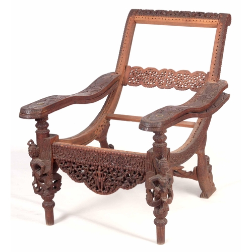 230 - AN UNUSUAL EARLY/MID 19TH CENTURY EASTERN/SOUTH SEAS PLANTATION CHAIR with swivelling underarms carv... 