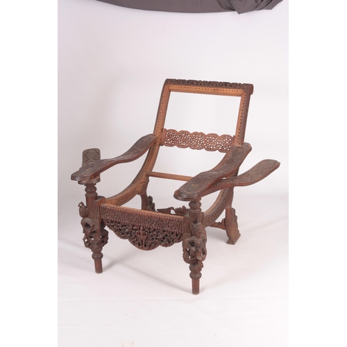 230 - AN UNUSUAL EARLY/MID 19TH CENTURY EASTERN/SOUTH SEAS PLANTATION CHAIR with swivelling underarms carv... 