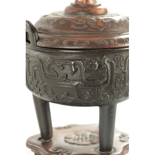 239 - AN EARLY CHINESE CAST BRONZE LIDDED CENSER the carved hardwood lid with jade foo dog finial and matc... 