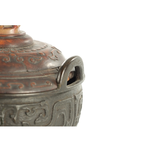 239 - AN EARLY CHINESE CAST BRONZE LIDDED CENSER the carved hardwood lid with jade foo dog finial and matc... 