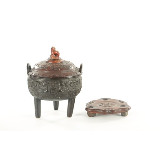 239 - AN EARLY CHINESE CAST BRONZE LIDDED CENSER the carved hardwood lid with jade foo dog finial and matc... 