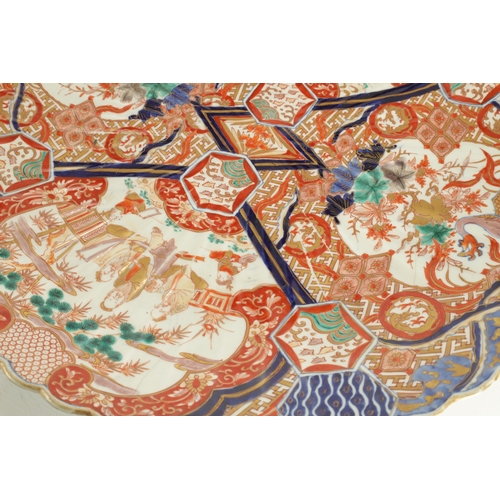 244 - A LARGE PAIR OF MEIJI PERIOD JAPANESE SCALLOP EDGE IMARI CHARGERS each well decorated in vibrant col... 