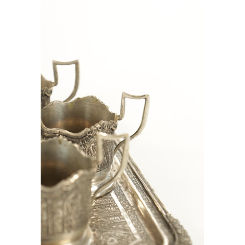 257 - A LATE 19TH CENTURY SILVER METAL PERSIAN COFFEE SET comprising of six cup holders, lidded bowl and t... 