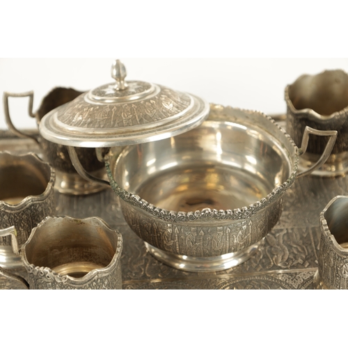 257 - A LATE 19TH CENTURY SILVER METAL PERSIAN COFFEE SET comprising of six cup holders, lidded bowl and t... 