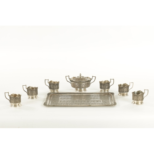 257 - A LATE 19TH CENTURY SILVER METAL PERSIAN COFFEE SET comprising of six cup holders, lidded bowl and t... 