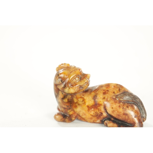 258 - A CHINESE CARVED RUSSET JADE SCULPTURE OF A RECUMBENT BEAST (6.5cm overall)