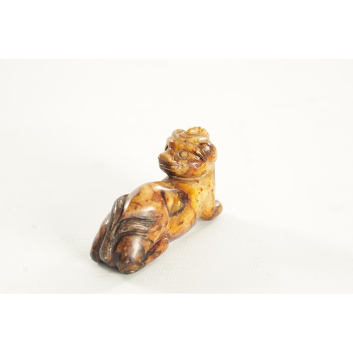 258 - A CHINESE CARVED RUSSET JADE SCULPTURE OF A RECUMBENT BEAST (6.5cm overall)