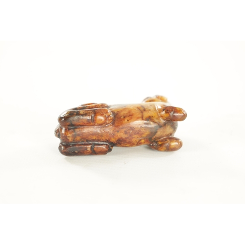 258 - A CHINESE CARVED RUSSET JADE SCULPTURE OF A RECUMBENT BEAST (6.5cm overall)