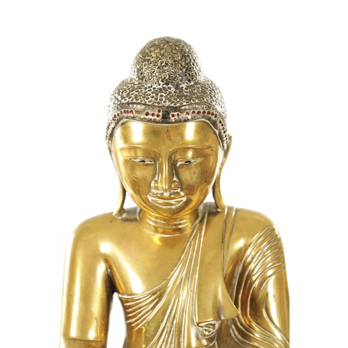 264 - AN 18TH CENTURY GILT BRONZE TIBETAN BUDDHA with jewelled headdress and enamel eyes (42cm high )