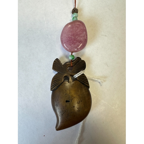 266 - A CHINESE RHINOCEROS HORN AND HARD STONE PENDANT with pink quartz and jade stones above an engraved ... 