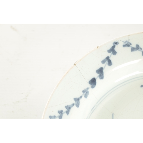 28 - AN 18TH CENTURY BLUE AND WHITE DELFT SHALLOW DISH with cottage landscape decoration (23cm diameter)