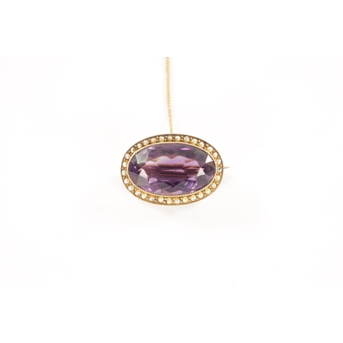 286 - A GOLD METAL AMETHYST AND PEARL BROOCH With large oval cut stone with a hinged pin and safety chain.... 