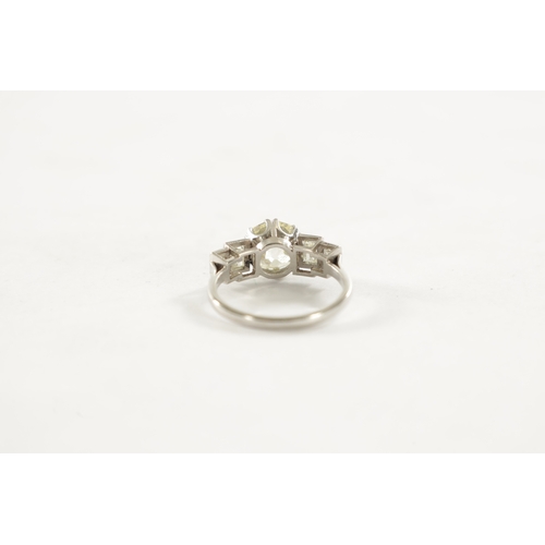 289 - A LADIES PLATINUM DIAMOND RING Having app. a 2.4ct brilliant cut centre diamond flanked by four bagu... 