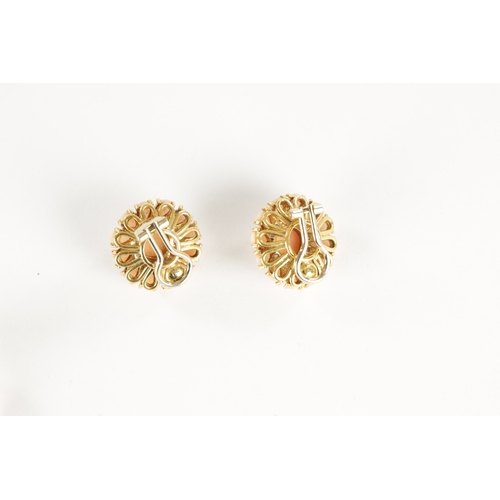 299 - AN 18CT GOLD PINK CORAL AND DIAMOND TWO SET RING AND EARRINGS With cabochon centre coral surrounded ... 