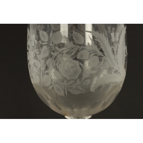 3 - AN OVERSIZED LATE 19TH CENTURY ENGRAVED GLASS COIN GOBLET the body having floral decoration and insc... 