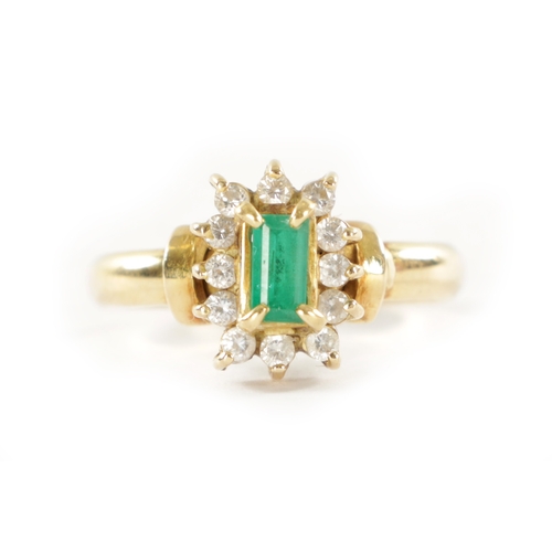 329 - AN 18CT GOLD EMERALD AND DIAMOND RING With baguette cut emerald surrounded by twelve brilliant cut d... 