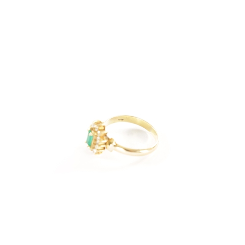 329 - AN 18CT GOLD EMERALD AND DIAMOND RING With baguette cut emerald surrounded by twelve brilliant cut d... 