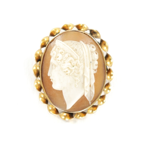 331 - AN ANTIQUE 9CT GOLD GRECIAN HEAD CAMEO BROOCH with twisted ribbon border. (33mm high)