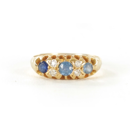 348 - A LADIES VINTAGE 18CT GOLD DIAMOND AND SAPPHIRE RING Set with diamonds and three sapphires on claw s... 