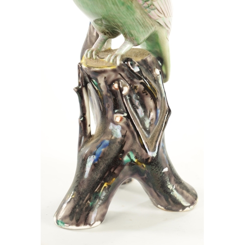 35 - A 19TH CENTURY CERAMIC PERCHED PARROT FIGURE the well modelled green glazed bird on a majolica type ... 