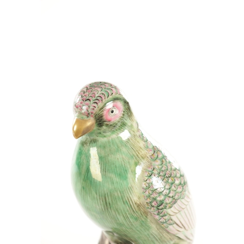 35 - A 19TH CENTURY CERAMIC PERCHED PARROT FIGURE the well modelled green glazed bird on a majolica type ... 