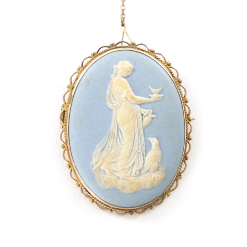 350 - AN ANTIQUE 9CT GOLD WEDGWOOD CAMEO BROOCH depicting classical lady and birds. (5cm high)