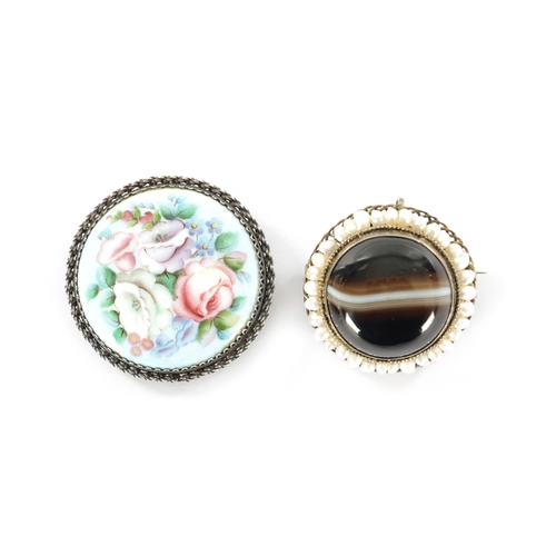 356 - TWO EARLY 20TH CENTURY SILVER BROOCHES one with enamel floral decoration, the other with agate caboc... 