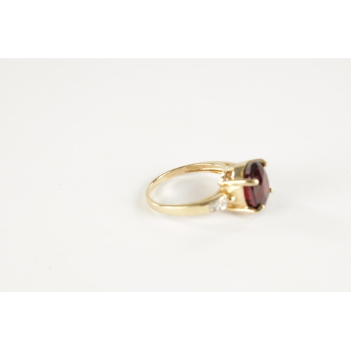 366 - A 9CT GOLD RUBELLITE AND DIAMOND RING The large stone in a four claw setting with diamond shoulders,... 