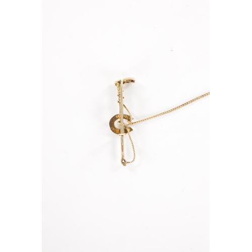 378 - AN EQUESTRIAN 9CT GOLD TURQUOISE AND PEARL BROOCH Modelled as a riding crop and horseshoe with safet... 