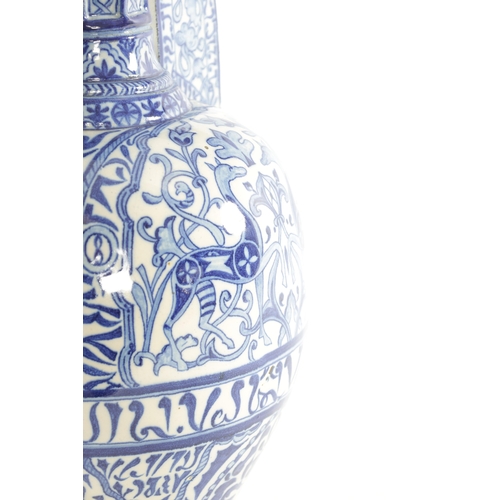 38 - A LATE 19TH CENTURY FRENCH ALHAMBRA EARTHENWARE BLUE AND WHITE VASE having deer set amongst leaf des... 